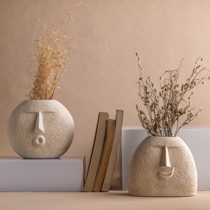 set of 2 oval shaped ceramic face vases in raw unglazed finish